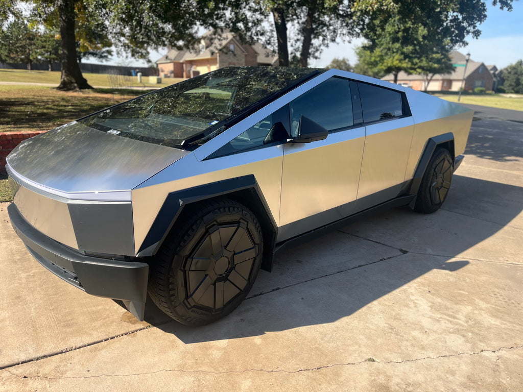 Futuristic car on a driveway with trees and houses in the background